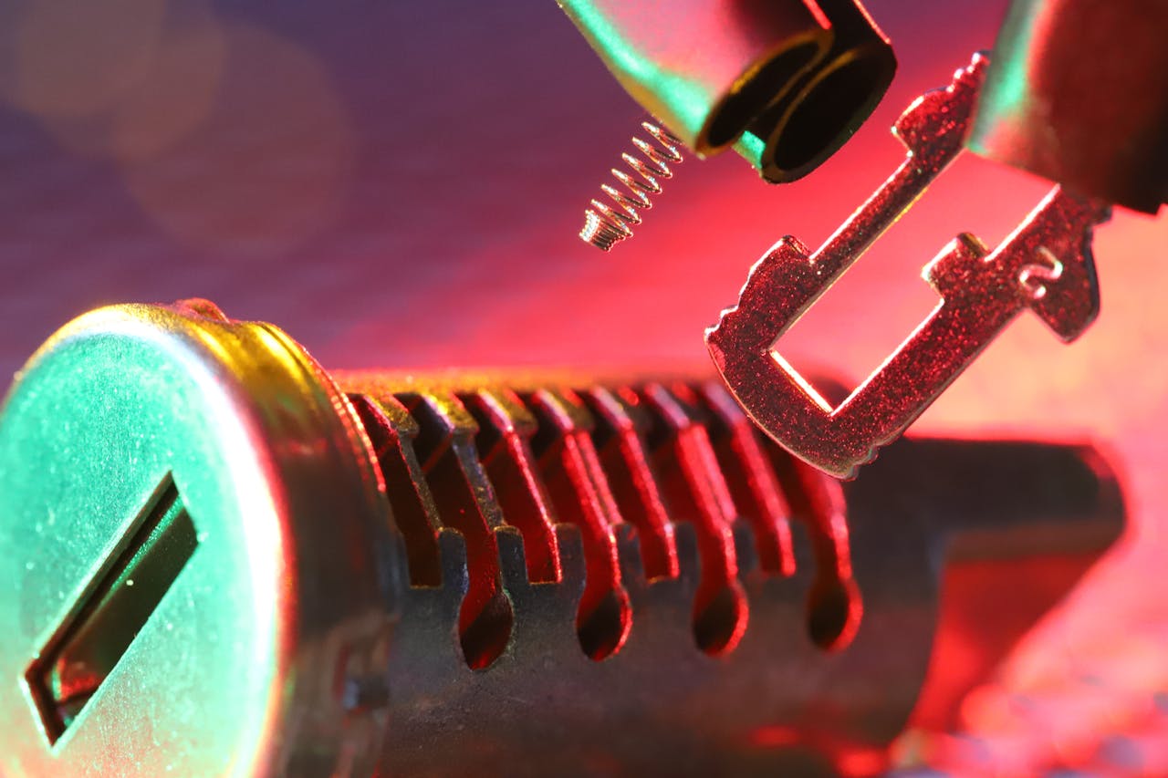 Macro shot of a mechanical lock cylinder and key, highlighting detailed components under vibrant lighting.